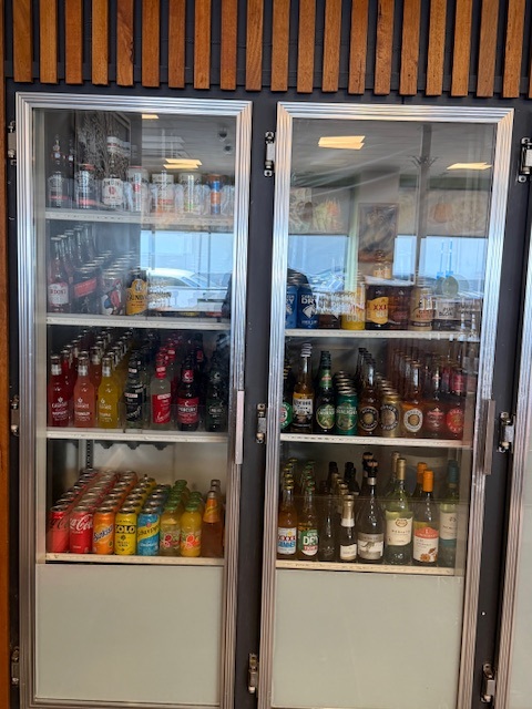 Display fridge with a rainbow of soft drinks, wines and beers
